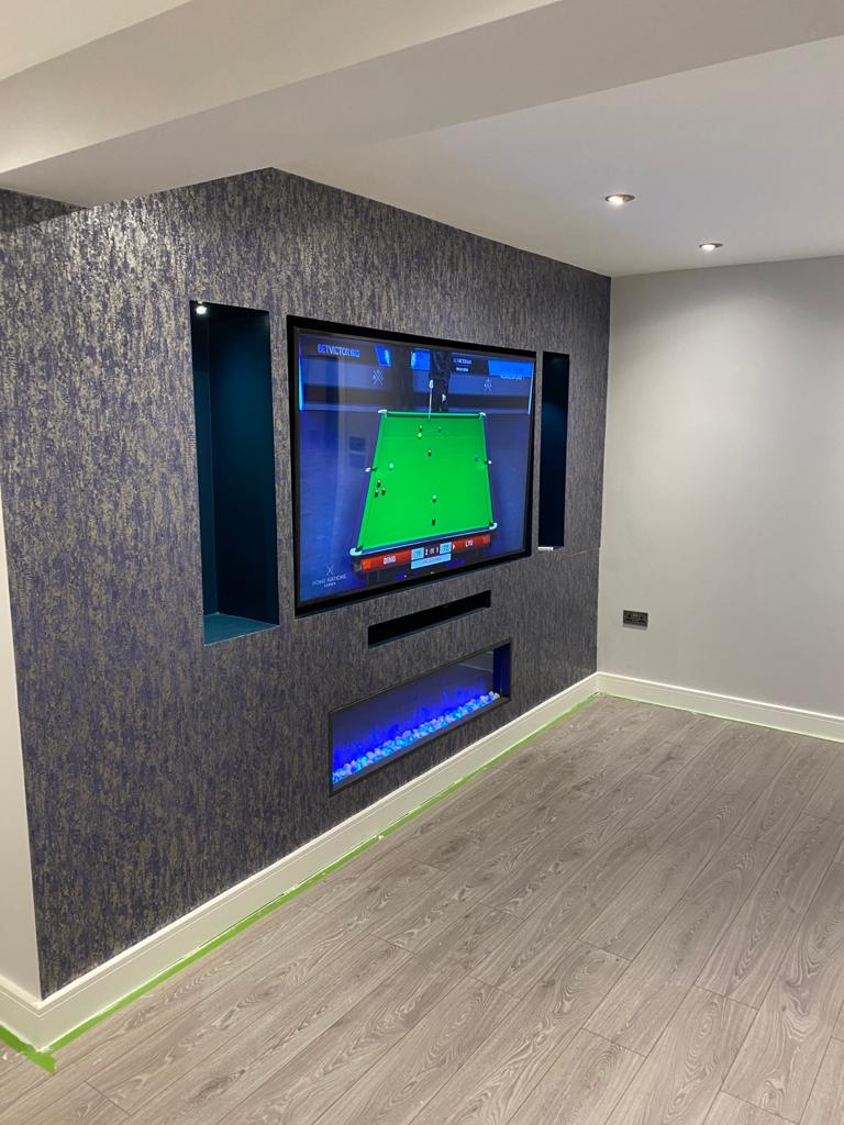 Custom built TV unit, complete with recessed display shelves.